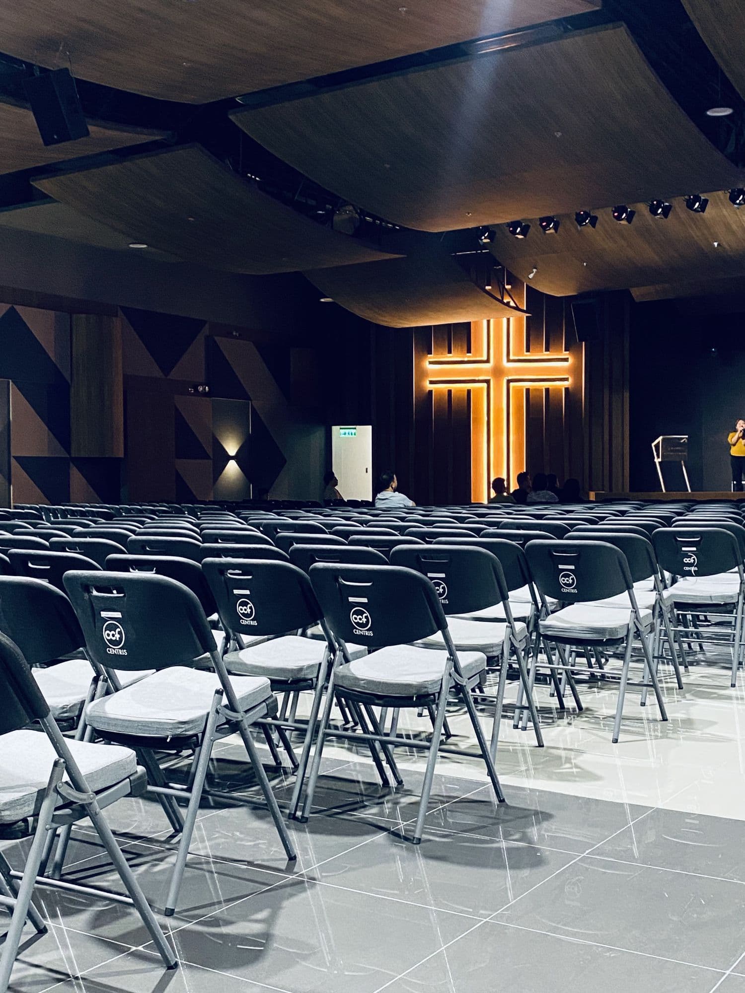 The main hall at CCF Centris, rows of chairs facing the lit cross