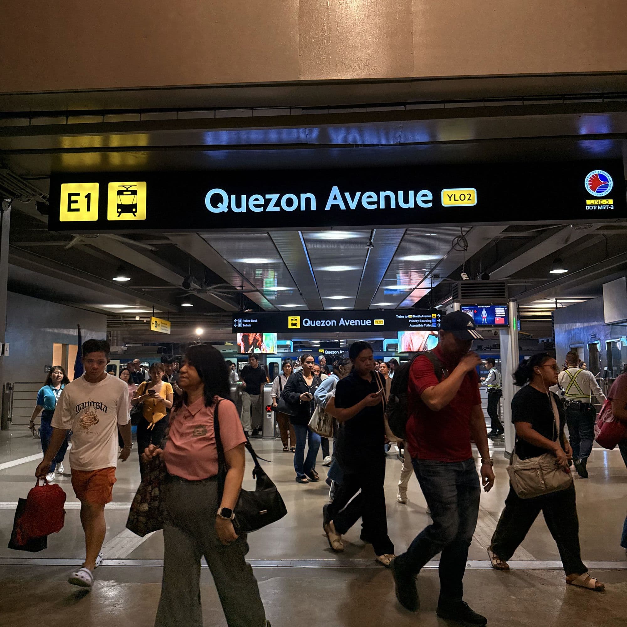 Inside MRT-3 Quezon Avenue station, under the Quezon Avenue sign